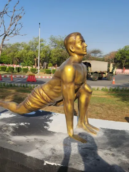 Another angle of the 'Ashwa Sanchalanasana' yoga pose statue, showing how it looks in its outdoor setting.