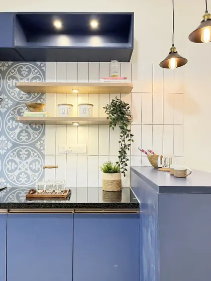 A close-up of the open shelving and subway tile backsplash, showing how different textures and materials can work together to create a harmonious design.