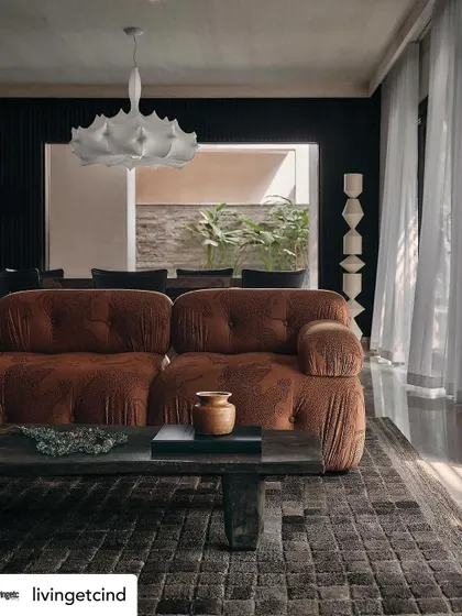 The living room, bathed in natural light, as seen in our Livingetc feature. The design balances dark, moody elements with bright, airy moments.