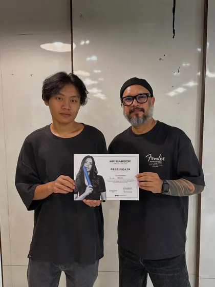 Every student gets the chance to shine and be recognized for their hard work. This student is receiving his certificate after an intensive advanced haircutting workshop.
