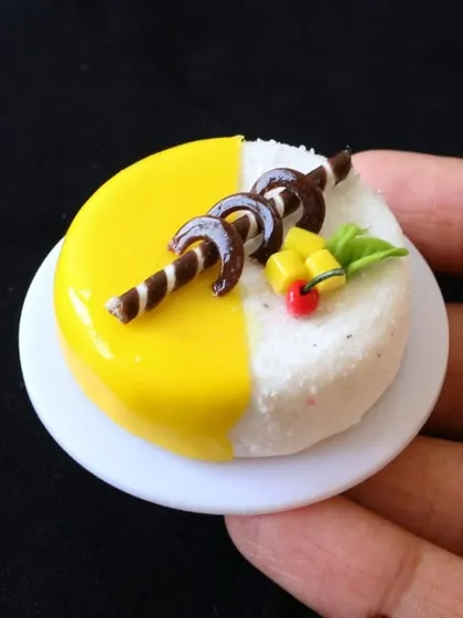 A close-up of a miniature mango cake, a perfect example of the hyper-realistic cakes you can create in my class.
