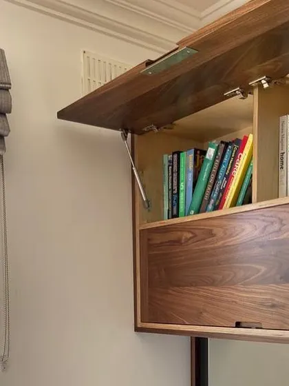 In addition to glassware, the upper cabinet was designed to hold the client's collection of cookbooks. This shows how I tailor each piece of fitted furniture to the owner's specific lifestyle and needs.