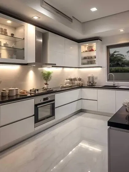 This L-shaped kitchen combines white cabinets with black countertops and appliances. The large window brings in plenty of natural light, and under-cabinet lighting ensures a well-lit workspace.