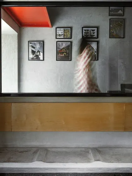 A small seating nook and gallery wall at a landing in our studio. These "moments" are designed as informal spaces for pause and reflection, showcasing extracts from our past projects.