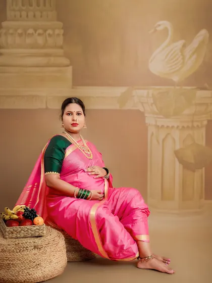 A classic pose with traditional elements like the swan and a basket of fruits, symbolizing fertility and prosperity. This studio setup is designed to honor our cultural heritage.