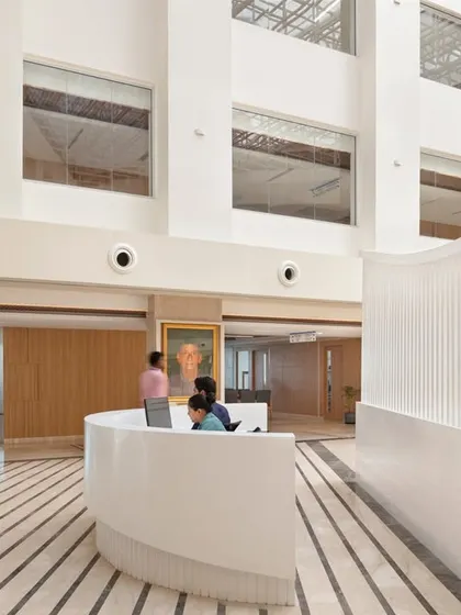 Healthcare interiors must be deliberate, serving function, comfort, and care. This reception area at Paras Yash Kothari Hospital uses clean lines, a neutral palette, and an open layout to create a welcoming and efficient space.