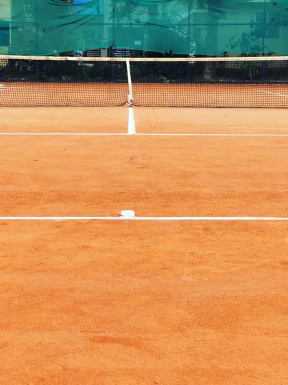 A close-up of the net and baseline on our well-kept clay court.