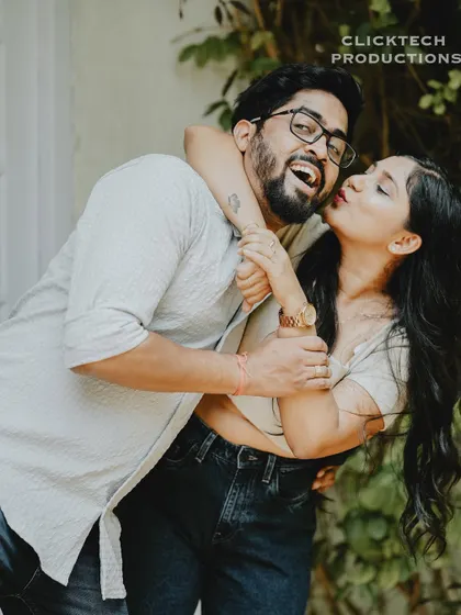 A joyful and energetic shot of the bride giving the groom a piggyback kiss, capturing their fun and loving relationship.