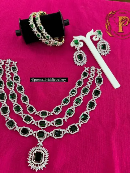 A grand, three-layered AD haram with large emerald-green stones. This statement piece is perfect for a bride who wants a truly royal look for her reception.
