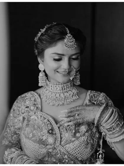 A beautiful black and white close-up of Sonali. This timeless portrait captures her gentle smile and the exquisite details of her bridal jewelry.
