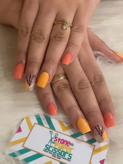 Bright and sunny nails featuring shades of orange and yellow. I added a touch of sparkle and a simple hand-painted design on an accent nail to complete the look.