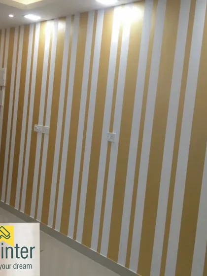 Elegant vertical stripes in gold and white create a sense of height and sophistication in this hallway. Pattern painting requires careful masking for crisp, clean lines.