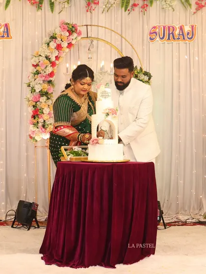 Here's a lovely couple cutting their four-tier engagement cake. It's always so special to see my creations as part of such a happy moment.