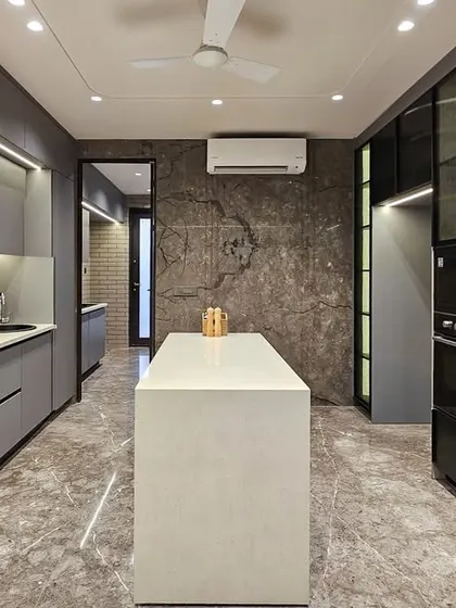 A full view of the modern grey kitchen, highlighting its spacious layout and integrated appliances. The design is a perfect balance of minimalist aesthetics and practical, family-friendly functionality.