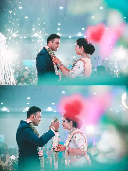 The Varmala ceremony during the reception, captured with beautiful bokeh and a celebratory feel, complete with indoor pyrotechnics.