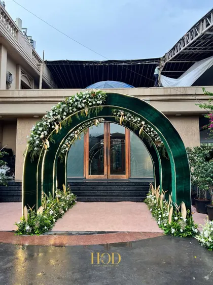 A beautiful green velvet archway adorned with white flowers and pampas grass. This entrance design is both luxurious and on-trend, perfect for a chic and modern ring ceremony or reception.