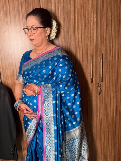 A side view showing her elegant hair bun adorned with a gajra, a classic touch for a traditional look.