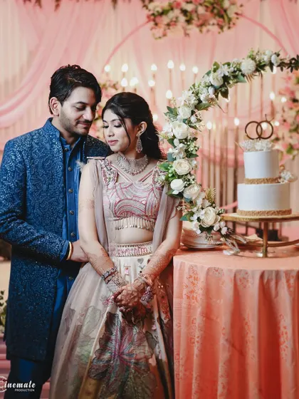 A sweet moment by the cake table. The couple's portrait here captures the beautiful decor and the elegance of their engagement party.
