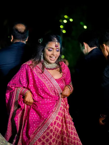 A candid shot of the bride dancing and enjoying her Mehandi night with guests.
