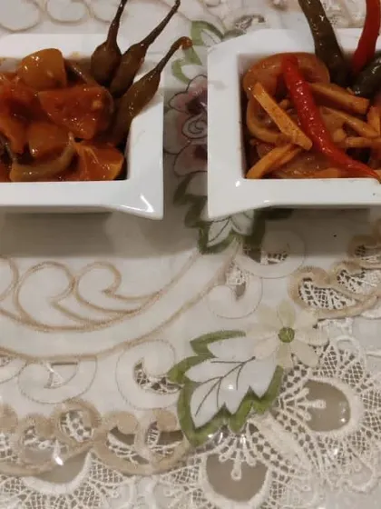 Two different styles of our mixed pickles served in small bowls. They are perfect for adding variety and flavour to your dining table.