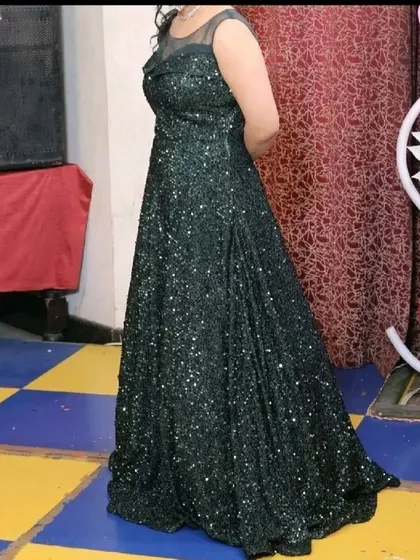 Our dark green sequined gown is a perfect rental for evening parties or receptions. It offers a sophisticated and glamorous look.