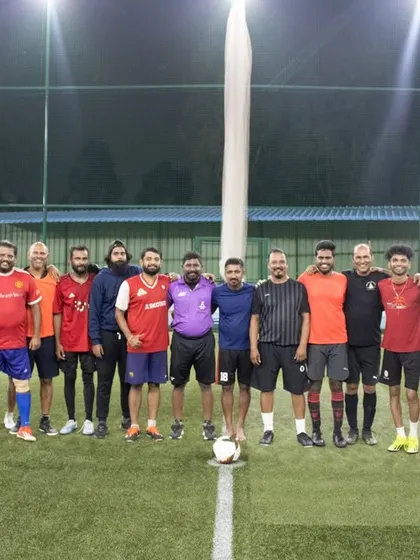 Both teams coming together for a group photo after the final match, showcasing the great spirit of community football events.