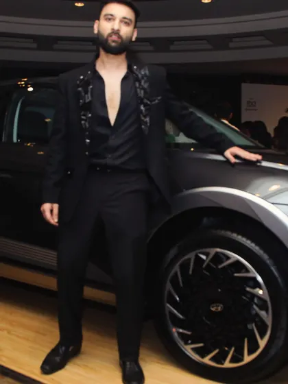 We create looks for high-profile events like India Couture Week. This all-black ensemble features a blazer with subtle floral embroidery on the lapels, offering a sophisticated and fashion-forward red carpet look.
