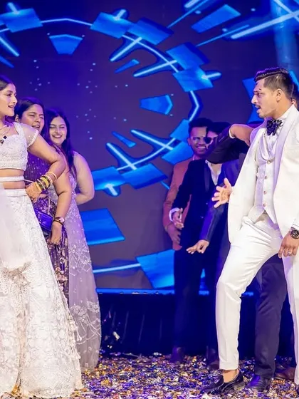 The couple and their friends share a laugh on stage at the end of a dance performance.