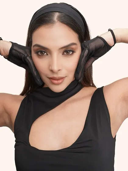 A confident and direct look to the camera, showcasing the clean and impactful makeup.