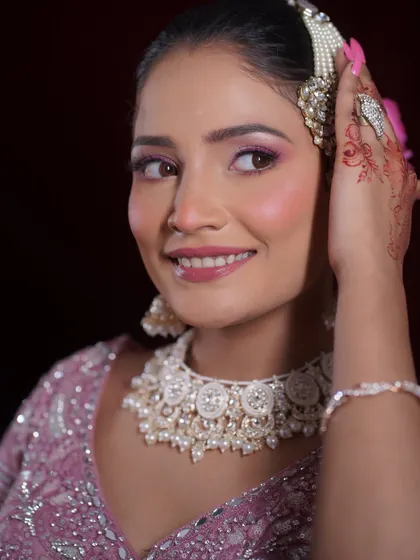 A happy, smiling shot of the bride. The makeup enhances her joy, with a focus on luminous skin and bright eyes.