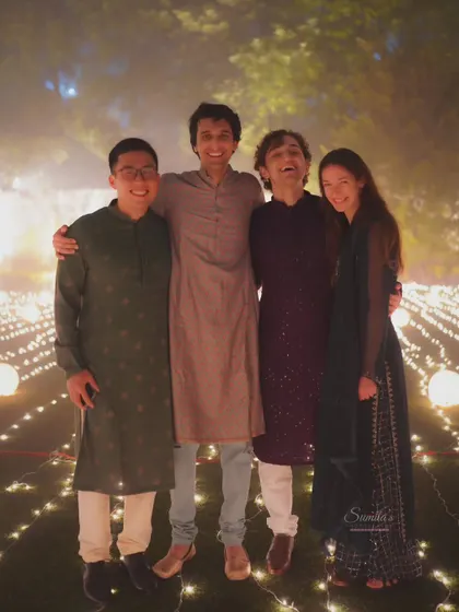 A candid group photo of friends at an evening function. The warm lighting and genuine smiles make this a lovely memory.
