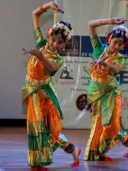 A synchronized pose from the talented Kuchipudi dancers.