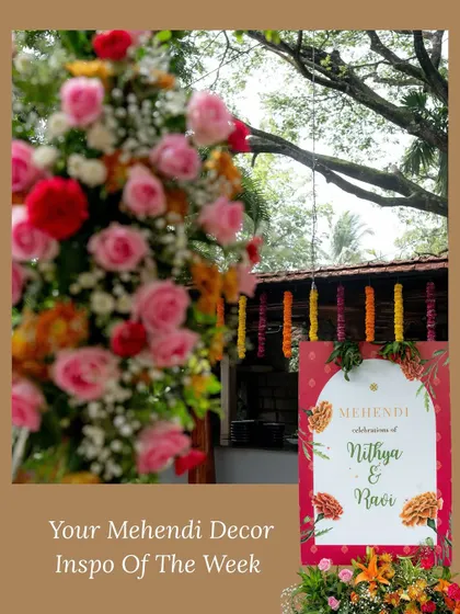 A personalized welcome sign for the Mehendi ceremony, framed by a beautiful floral arrangement, setting the tone for a colorful and personalized event.