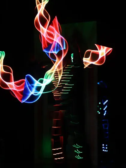 A long-exposure shot capturing the beautiful trails of light created by our Pixel Poi artist, blending multiple colors into a flowing ribbon of light.