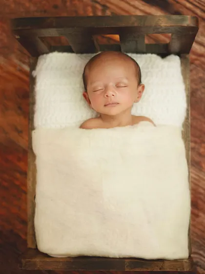 There is something so angelic about a baby sleeping soundly in a tiny bed. I use soft, fluffy blankets to ensure they are completely comfortable and secure during the shoot.
