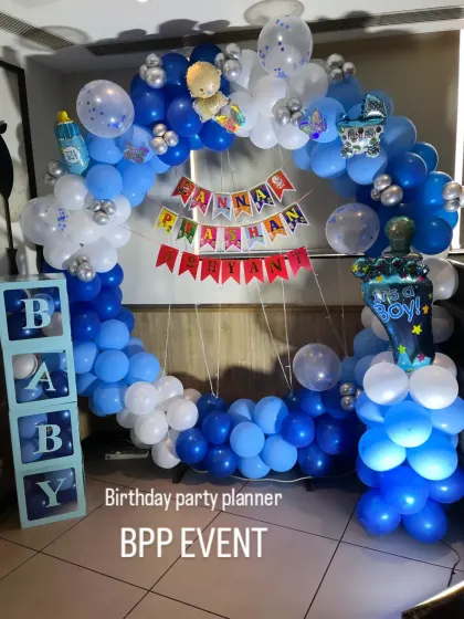 A full view of the Annaprashan ring backdrop, with 'It's a Boy' and baby bottle foil balloons.