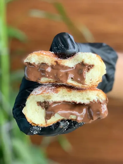 A cross-section of our Nutella Berliner, oozing with rich chocolate hazelnut spread. This one is a favourite for kids and adults alike.