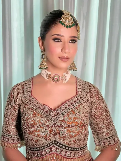 A new era bridal look with a focus on smokey eyes and a heavy, traditional blouse.