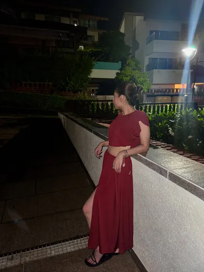 A side profile of the red co-ord set, showing the back and the relaxed fit.