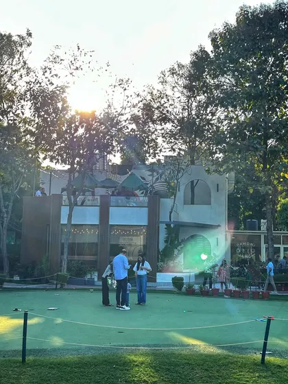 The putting green, with the cafe in the background, offers a complete experience for your guests to play and relax.