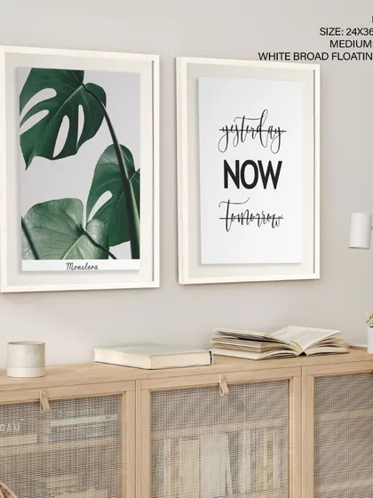 A modern and motivational set of two prints, pairing a Monstera leaf photograph with a "Yesterday, Now, Tomorrow" typographic design. The white broad floating frames give it a clean, gallery-like feel.