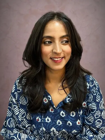 Adding volume and movement to long, straight hair with curtain bangs and butterfly layers.