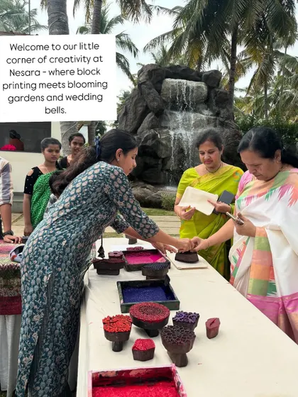 Welcome to our little corner of creativity at a Nesara wedding. Set against a backdrop of blooming gardens and a beautiful waterfall, our station became a hub where guests gathered to try their hand at block printing.