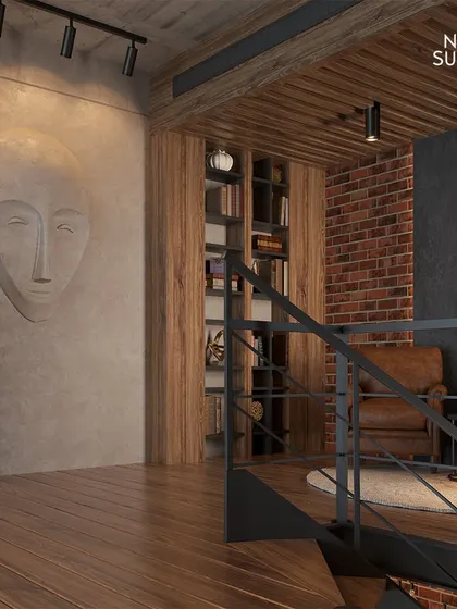 This reading nook on the mezzanine level features exposed brick and a comfortable leather armchair. It’s a perfect example of how we carve out intimate, cozy corners within a larger, open-plan design.