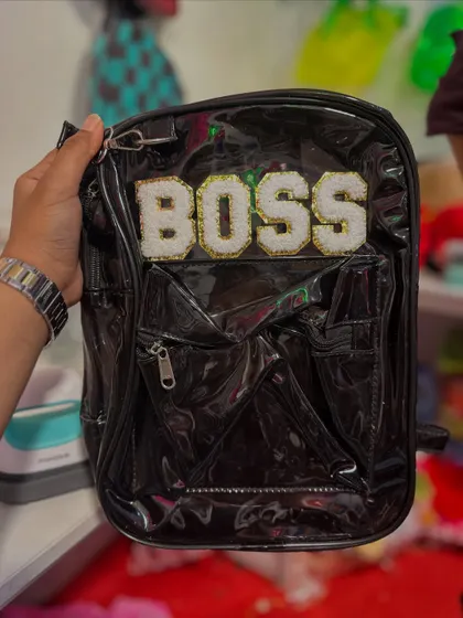 This black backpack makes a bold statement with "BOSS" spelled out in sparkly patches.