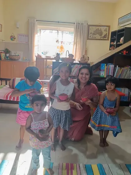 Children pose with their painted coconut shells, a unique craft activity from a story about a noisy home.