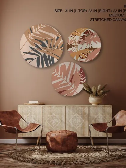 This set of three circular stretched canvas prints showcases abstract botanical silhouettes. The earthy tones and minimalist designs are perfect for adding a touch of nature to a modern, bohemian-style room.