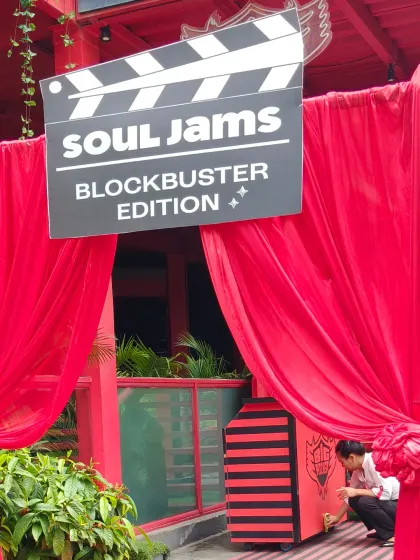 Here is a Bollywood theme entrance I designed for a 'Blockbuster Edition' event. I used bold red drapes and a custom clapperboard prop to set a filmy mood right from the start.
