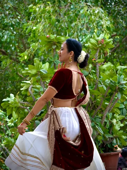 A side profile showing the details of the costume and the elegant posture. Every detail matters in creating a visually captivating dance piece.