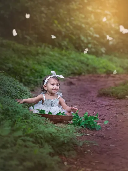 A joyful moment as the toddler smiles, surrounded by a flurry of white butterflies. This image perfectly captures the carefree magic of childhood.